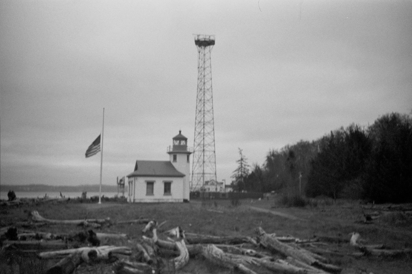 A black and white film photograph of a lighthouse